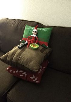 an elf is sitting on the couch with some pillows