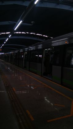 an empty subway station with no people on the platform or in front of it at night