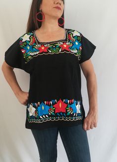 Be a trend with these beautiful mexican blouse made by hand in Chiapas, Mexico creating fashion and art. This is a beautiful blouse with colorful flowers and short sleeve. Very comfortable, Goes great with jeans, leggings, skirt, shorts... Each piece is unique and handmade with dedication and taking care of every detail achieving the best quality in our products, which is why it makes it beautiful and unique each of the embroidered flowers. Colors and flowers may vary depending on the size shown Folk Style Tops With Geometric Embroidery And Short Sleeves, Folk Style Short Sleeve Top With Geometric Embroidery, Embroidered Multicolor Short Sleeve Tops, Multicolor Embroidery Short Sleeve Festival Tops, Multicolor Short Sleeve Tops With Embroidered Neckline, Multicolor Tops With Embroidered Neckline And Short Sleeves, Multicolor Embroidery Short Sleeve Tops For Festival, Festival Short Sleeve Blouse With Geometric Embroidery, Festival Embroidered Top With Short Sleeves