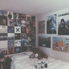 a bedroom with posters on the wall and a teddy bear