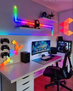 a computer desk topped with a monitor and two gaming headset on top of it