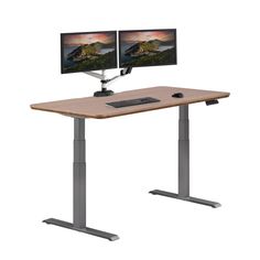 a computer desk with two monitors sitting on it's sides, and one monitor is turned on