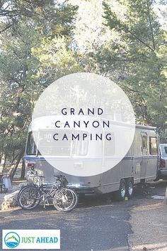 a camper trailer parked next to a forest with the words grand canyon camping written over it