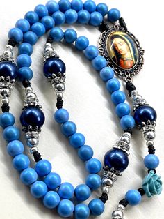 Handmade Rosary with Bronze Lady of Guadalupe centerpiece beautiful blue wooden beads and large blue Pearl Pater beads includes Indulgence bronze crucifix Catholic gift Communion gift  Catholic mom gift God parent gift These rosaries are beautiful and would make a wonderful First Communion/Reconciliation or Confirmation gift, wedding gift, or RCIA PSR gift.  The colors are vibrant and gorgeous!   The bronze Indulgence pardon  crucifix is Made in Italy  Bronze Lady of Guadalupe centerpiece is col Catholic Kids Crafts, Rosary Case, Godparent Gifts, Catholic Kids, Lady Of Guadalupe, Communion Gifts, Rosary Necklace, Confirmation Gifts, God Parents