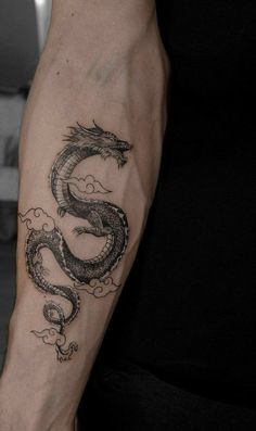 a man with a dragon tattoo on his arm