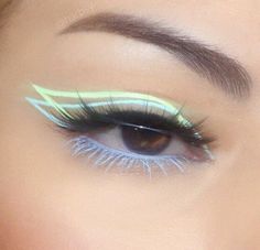 a woman's eye with blue and green makeup