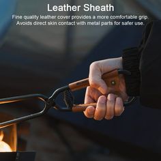 a person holding a pair of scissors in front of an open fire pit with the words leather shear on it