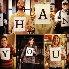 a group of people holding up letters that spell out the word h and y in front of them