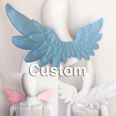 three mannequins with blue and pink wings on them