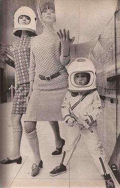 an old photo of two children dressed up as astronauts and one is waving at the camera