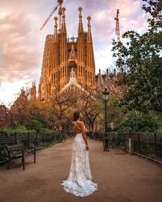 a woman standing in front of a cathedral