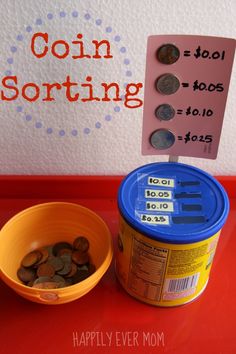 coins are in a bucket next to a sign that says coin sorting