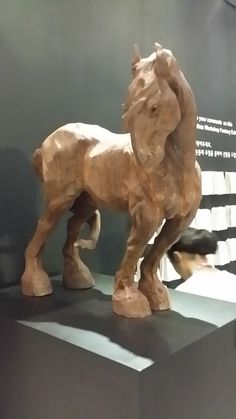 a wooden horse on display in a museum