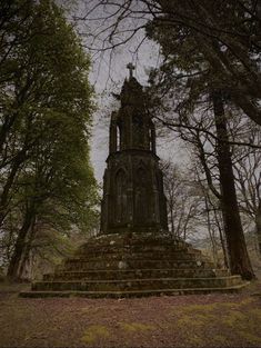 a very tall tower sitting in the middle of a forest