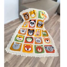 there is a crocheted blanket with animals on it