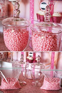 there are pink candies in glass containers on the table