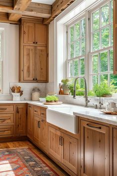 a kitchen filled with lots of wooden cabinets and white counter tops next to a window