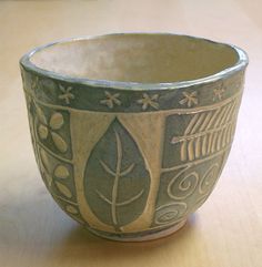 a ceramic bowl sitting on top of a wooden table