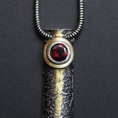 Textured Silver and Gold Pendant with Deep Red Garnet by Abi Cochran on Etsy (reticulated, oxidised, keum-boo). Gold Necklaces, Gold Pendant Necklace, Gold Leaf