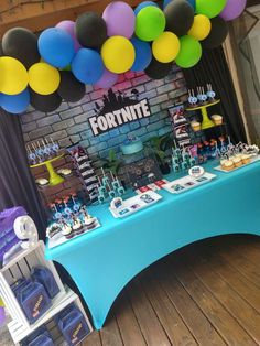 a table topped with lots of cake and balloons