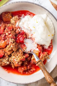 a white bowl filled with fruit and ice cream