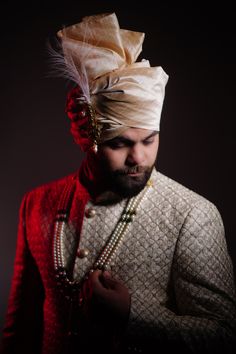 a man with a turban and pearls on his head