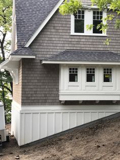 a gray house with white trim and windows