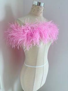 a mannequin with pink feathers on it