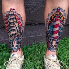 two people with tattoos on their legs standing in the grass