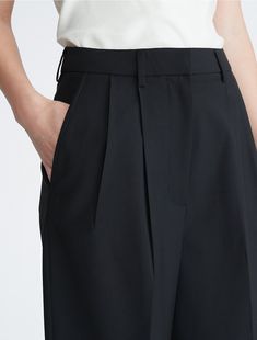 Cut in a wide leg silhouette, these trousers are well suited for elevated, refined outfits. Made with pleated styling for tailored shape. Designed with a zip fly and a clasp closure.  Material: 52% Polyester, 43% Wool, 5% Elastane. Business Casual Wide-leg Pleated Pants, Classic Wide-leg Pants With Pleated Waist, Timeless Semi-formal Wide Leg Bottoms, Chic Wide Leg Office Pants With Welt Pockets, Chic Wide Leg Pants With Welt Pockets For Office, Chic Pleated Waist Bottoms For Workwear, Modern Wide Leg Pants With Welt Pockets, Classic Wide Leg Culottes, Classic Wide Leg Bottoms With Accordion Pleats