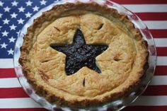 a pie with a star on it sitting in front of an american flag