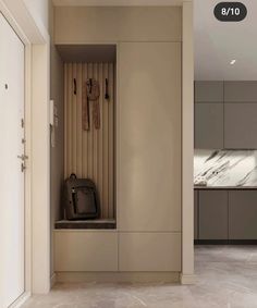 an open door leading to a kitchen with marble counter tops and cabinets on either side