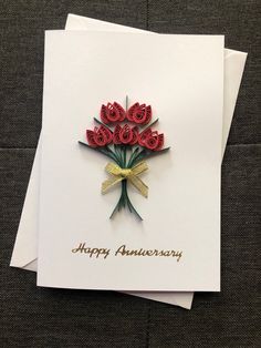 an anniversary card with red flowers on it