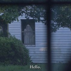 an image of a ghost in the window of a house with words written below it