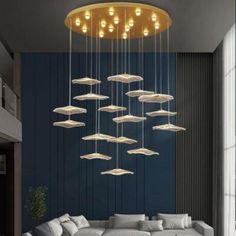 a living room filled with lots of white furniture and lights hanging from it's ceiling