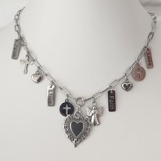 Introducing our beautiful Religious Multi Charm Necklace, a piece that combines spirituality and style! This necklace stands out for the central charm of the Sacred Heart inspired by Mexican Miracles, accompanied by mini cross charms, angels and other symbols of faith.  This Ex Voto Necklace is made with a clip-type chain, made of stainless steel, guarantees durability and water resistance, without losing its shine and quality over time.  This piece of Catholic jewelry, Inspired by Mexican Jewelry for those who want to carry their faith with them in an elegant and modern way. Ideal as a meaningful gift or to enrich your own jewelry collection. Add a touch of spirituality to your look with this exceptional necklace! Symbols Of Faith, Heart On Fire, Jesus Necklace, The Sacred Heart, Sacred Heart Of Jesus, Necklace Stand, Mexican Jewelry, Catholic Jewelry, Mini Cross