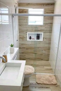 a bathroom with a toilet, sink and shower stall is shown in this image from the front view