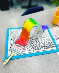 an art project for kids to do with colored paper and crayons on the table