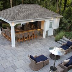 an outdoor living area with patio furniture and bar in the back yard is shown from above