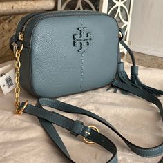 Brand New Tory Burch Mcgraw Camera Bag Color Arctic Height: 5" (12.8cm); Length: 7.6" (19.2cm); Depth: 1.9" (4.7cm) Pebbled Leather Microfiber Lining With A Suede-Like Finish Brass Hardware Zipper Closure Adjustable Chain And Leather Crossbody Strap With 22.2" (56.5cm) Drop 1 Exterior Back Wall Slit Pocket, 1 Interior Slit Pocket Pickstitch Detail Dust Bag Included Small Crossbody Tory Burch Camera Bag, Tory Burch Fleming Bag, Tory Burch Robinson Tote, Tory Burch Crossbody, Quilted Crossbody Bag, Convertible Bags, Tory Burch Bag, Kate Spade Handbags, Black Purses