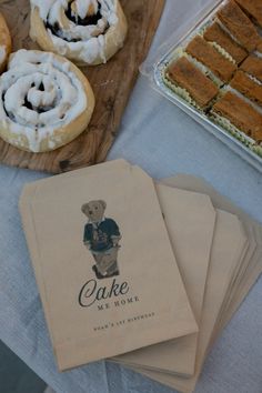 several pastries are sitting on a table next to some napkins that say cake and honey