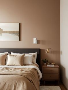 a bedroom with a bed, nightstand and painting on the wall