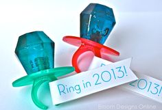 three ring in 2013 magnets sitting on top of a white table next to each other