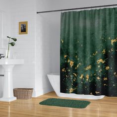 a bathroom with a green shower curtain next to a white bath tub and wooden floor