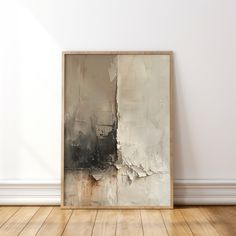 an abstract painting is displayed on the wall next to a wooden floor in front of a white wall