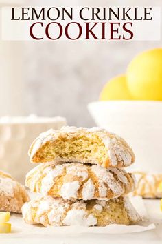 lemon crinkle cookies stacked on top of each other with powdered sugar and fresh lemons in the background