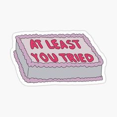 a pink and gray cake with the words at least you tried on it sticker