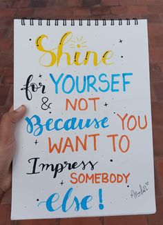 someone holding up a sign that says shine for yourself and not because you want to imperson somebody else