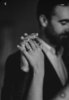 black and white photograph of a man and woman holding each other's hands together