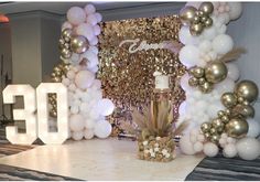 a table topped with balloons and cake next to a number 30 sign that says 30th